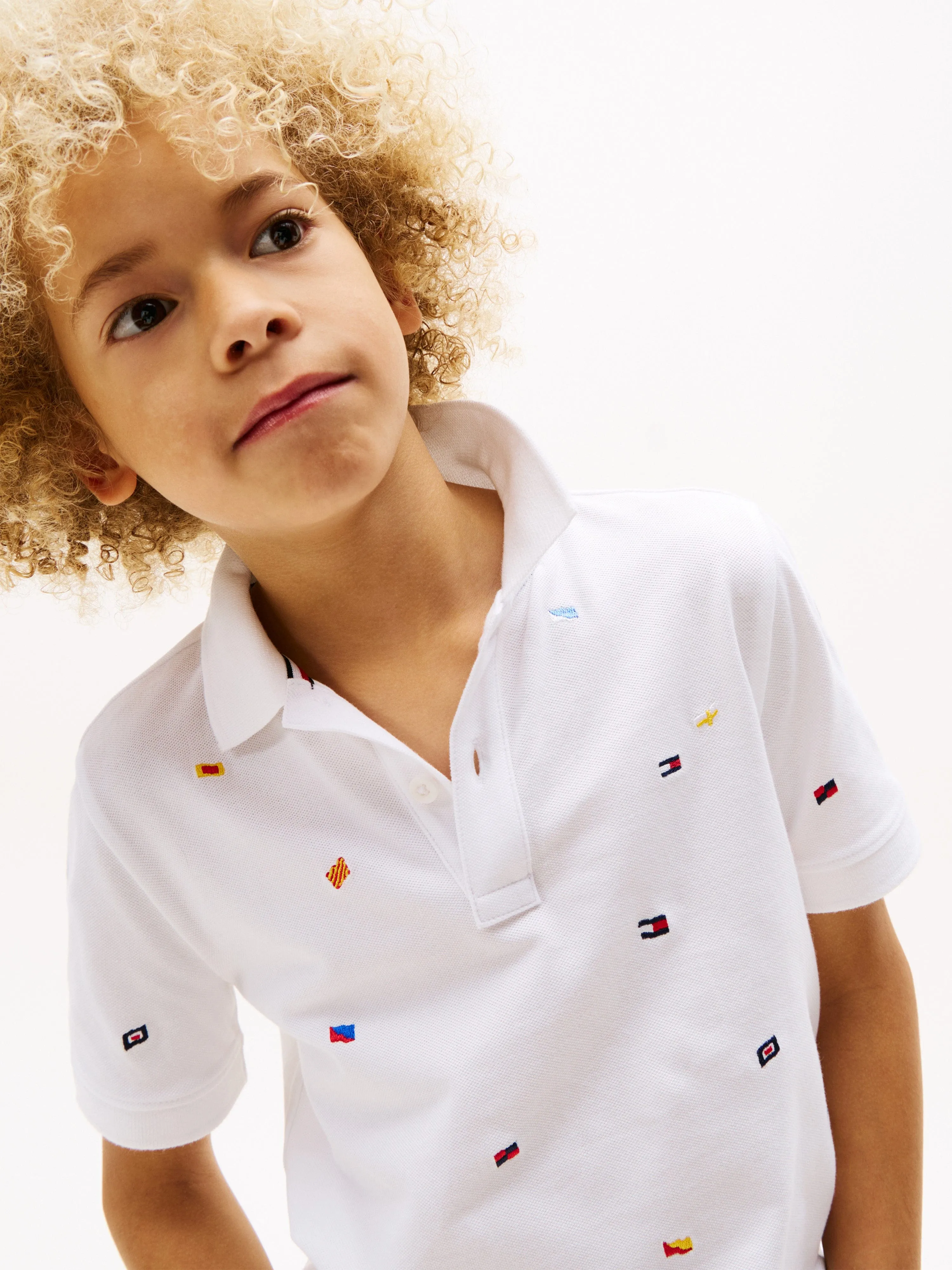 Tommy Hilfiger Boys All Over Flag Embroidered Polo Shirt in White